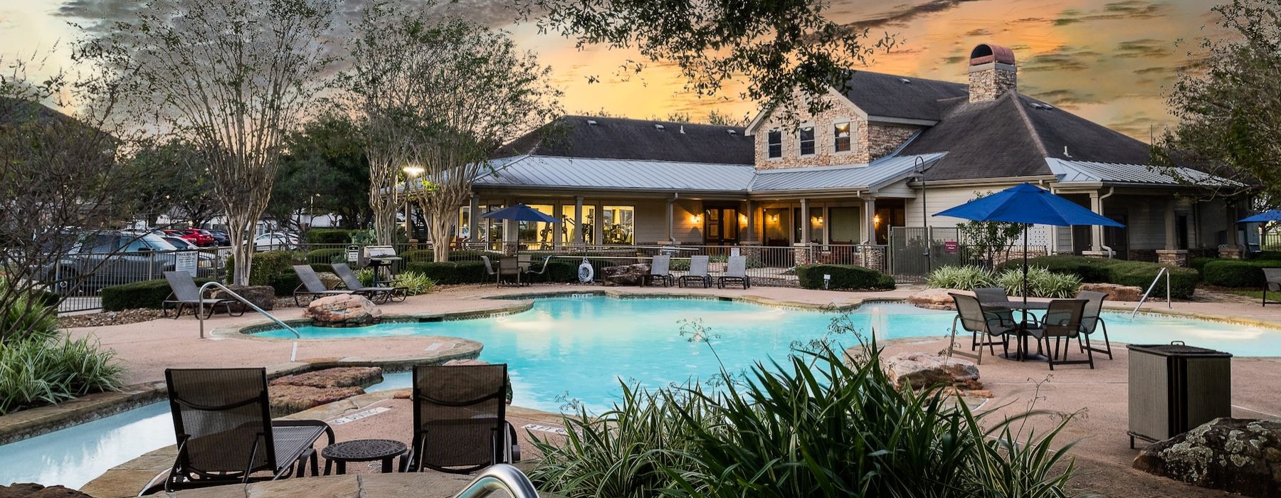 a pool with chairs and umbrellas by it