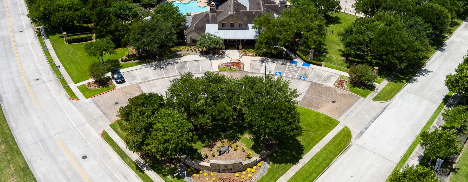 a large green landscape with houses and trees