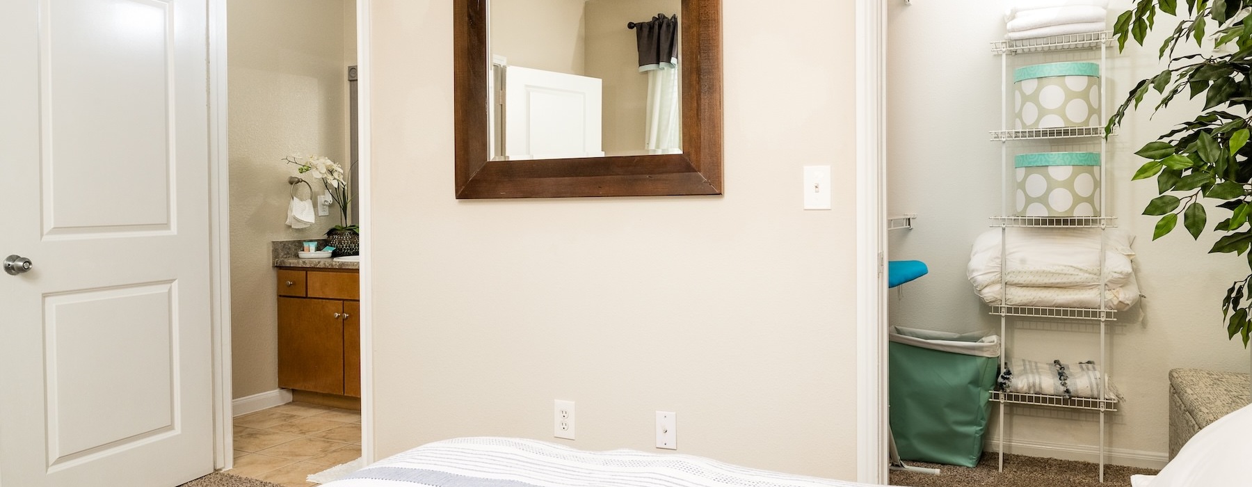 a bedroom with a mirror and a bed