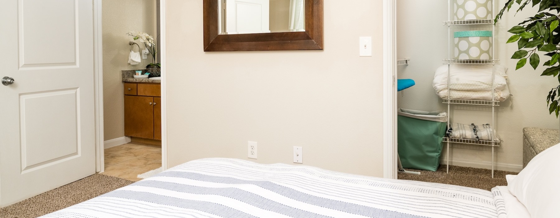 a bedroom with a mirror and a bed