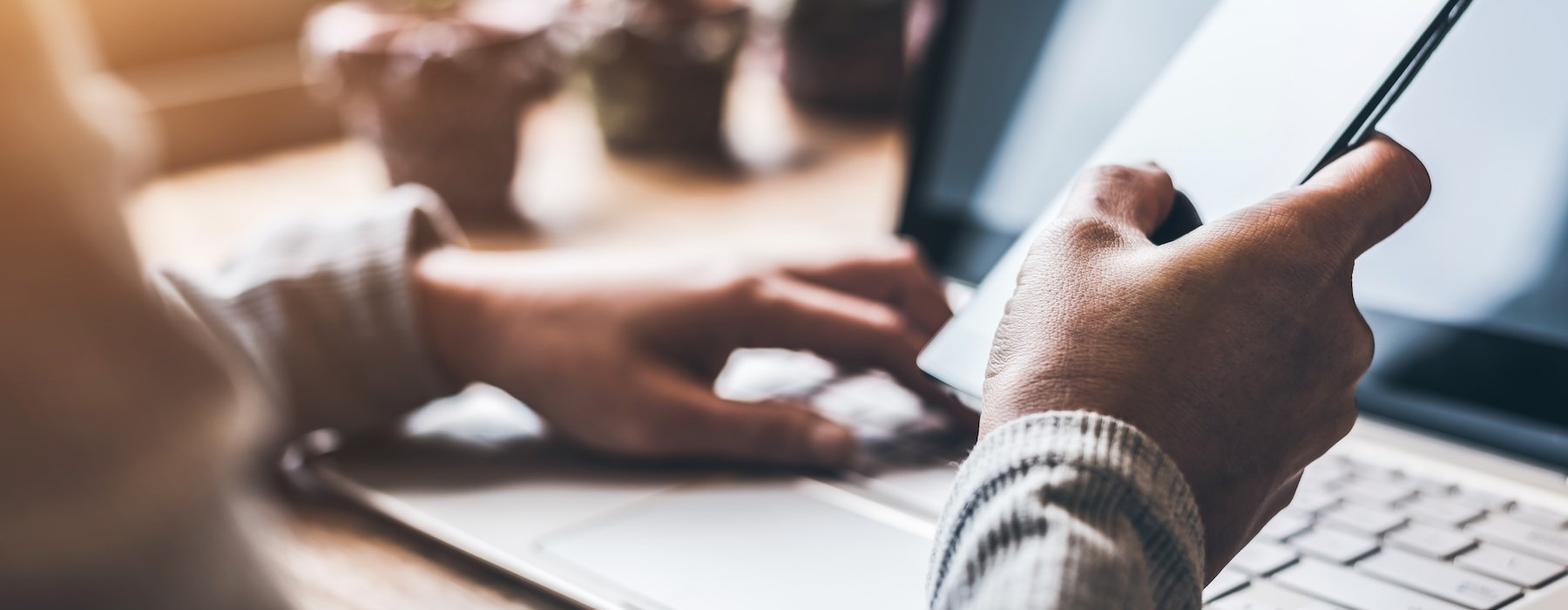 a close-up of hands using a laptop