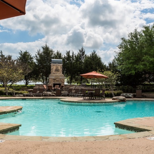 a swimming pool with trees in the background