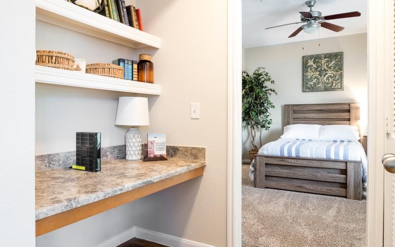 a room with a bed and shelves