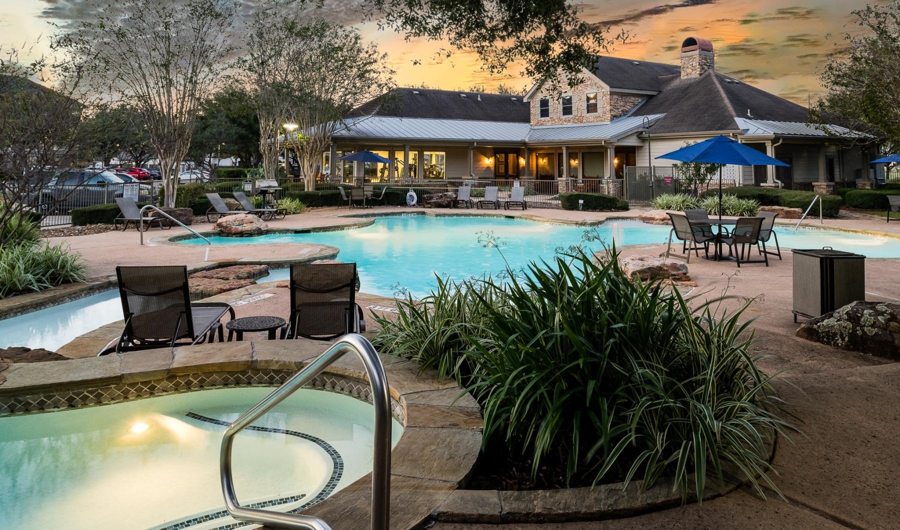 a pool with chairs and umbrellas by it